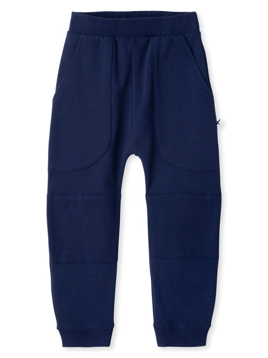 Minti kids clothing. Super cool baggy trackies featuring elastic waistband, front pockets, back pocket, 2x2 rib cuffs and reinforced 2x2 rib knee patches. Minti embroidery on the back pocket. 330 Gram // Brushed Inside // 95% Cotton // 5% Elastane.