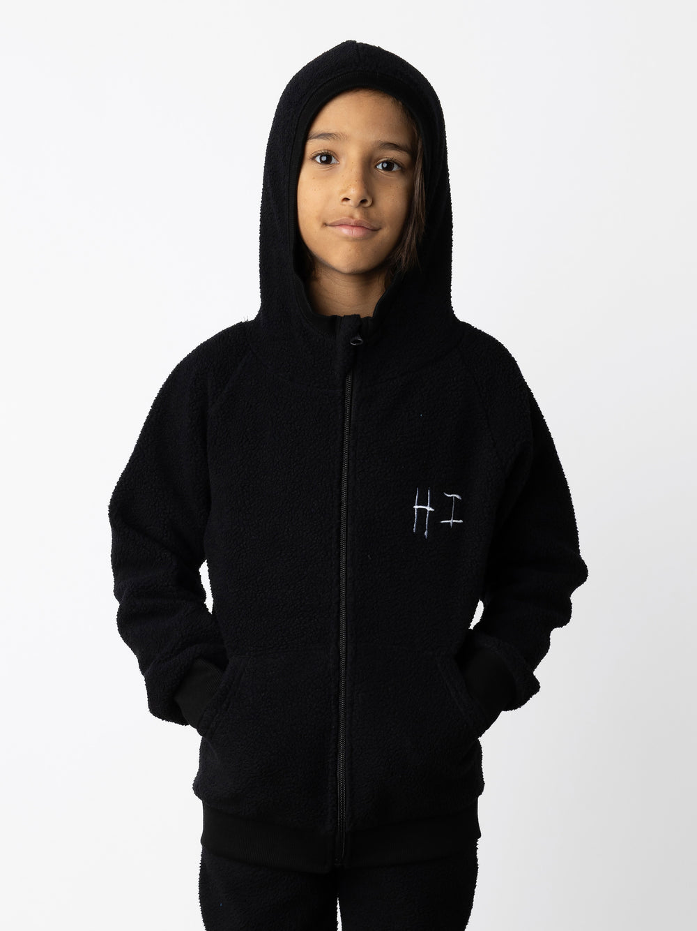 Minti kids clothing. Super cosy and soft Zip Up made in teddy with 2x2 rib cuffs and hem. Front pocket to keep hands warm. 70% Polyester // 30% Cotton.