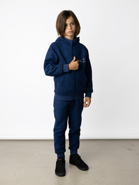 Minti kids clothing. Super cosy and soft Zip Up made in teddy with 2x2 rib cuffs and hem. Front pocket to keep hands warm. 70% Polyester // 30% Cotton.