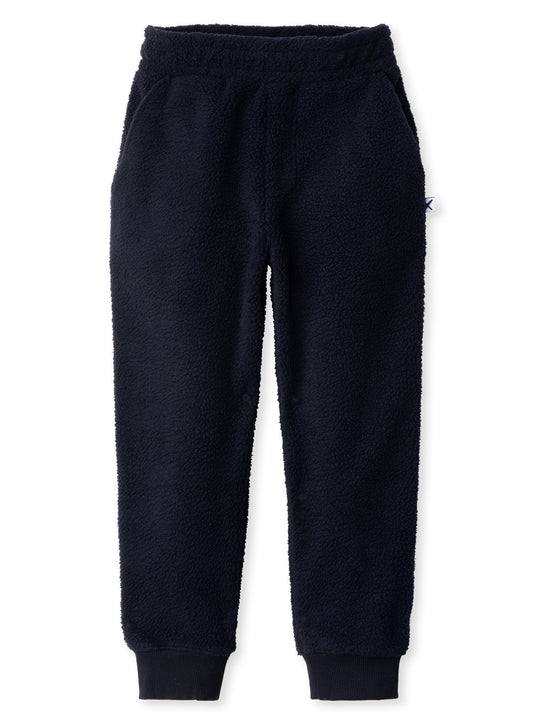 Minti kids clothing. Super cosy and soft loose leg trackies made in teddy with 2x2 rib cuffs. Front pocket to keep hands warm. Small Minti embroidery on the back. 70% Polyester // 30% Cotton.
