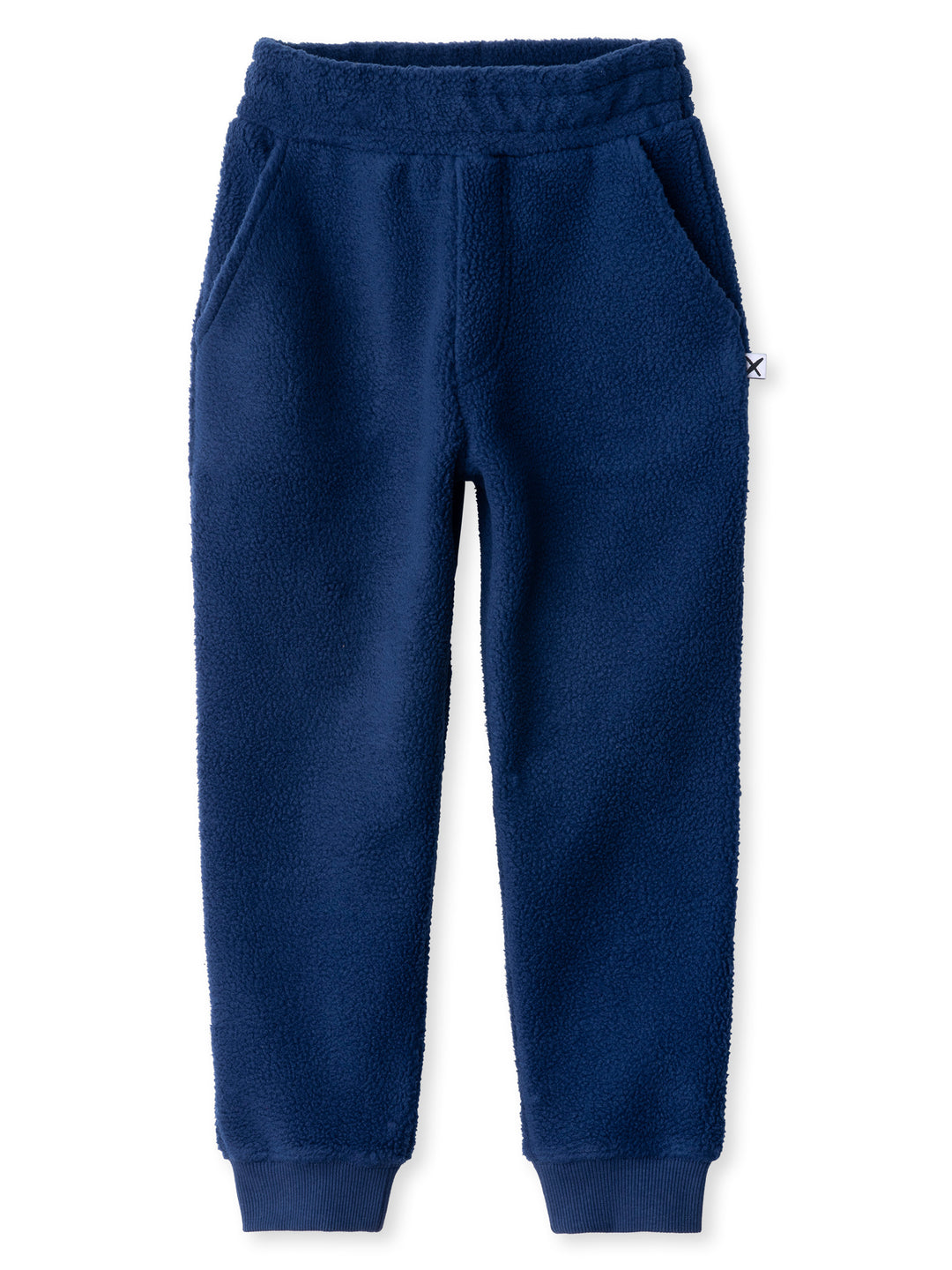 Minti kids clothing. Super cosy and soft loose leg trackies made in teddy with 2x2 rib cuffs. Front pocket to keep hands warm. Small Minti embroidery on the back. 70% Polyester // 30% Cotton.