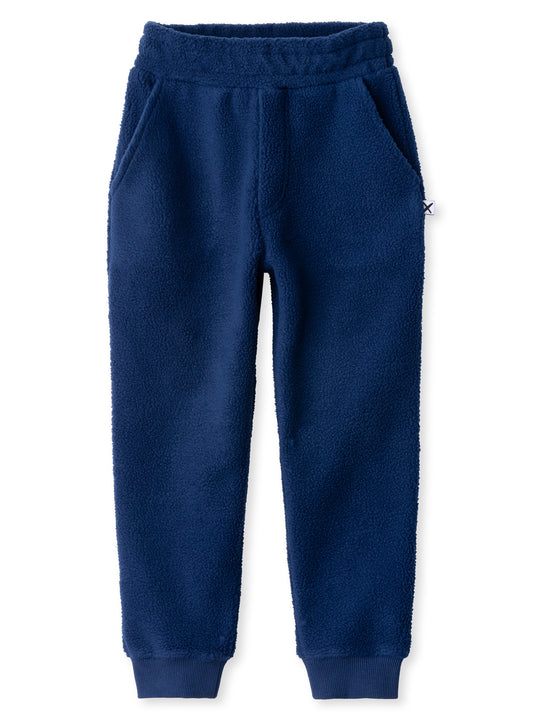 Minti kids clothing. Super cosy and soft loose leg trackies made in teddy with 2x2 rib cuffs. Front pocket to keep hands warm. Small Minti embroidery on the back. 70% Polyester // 30% Cotton.