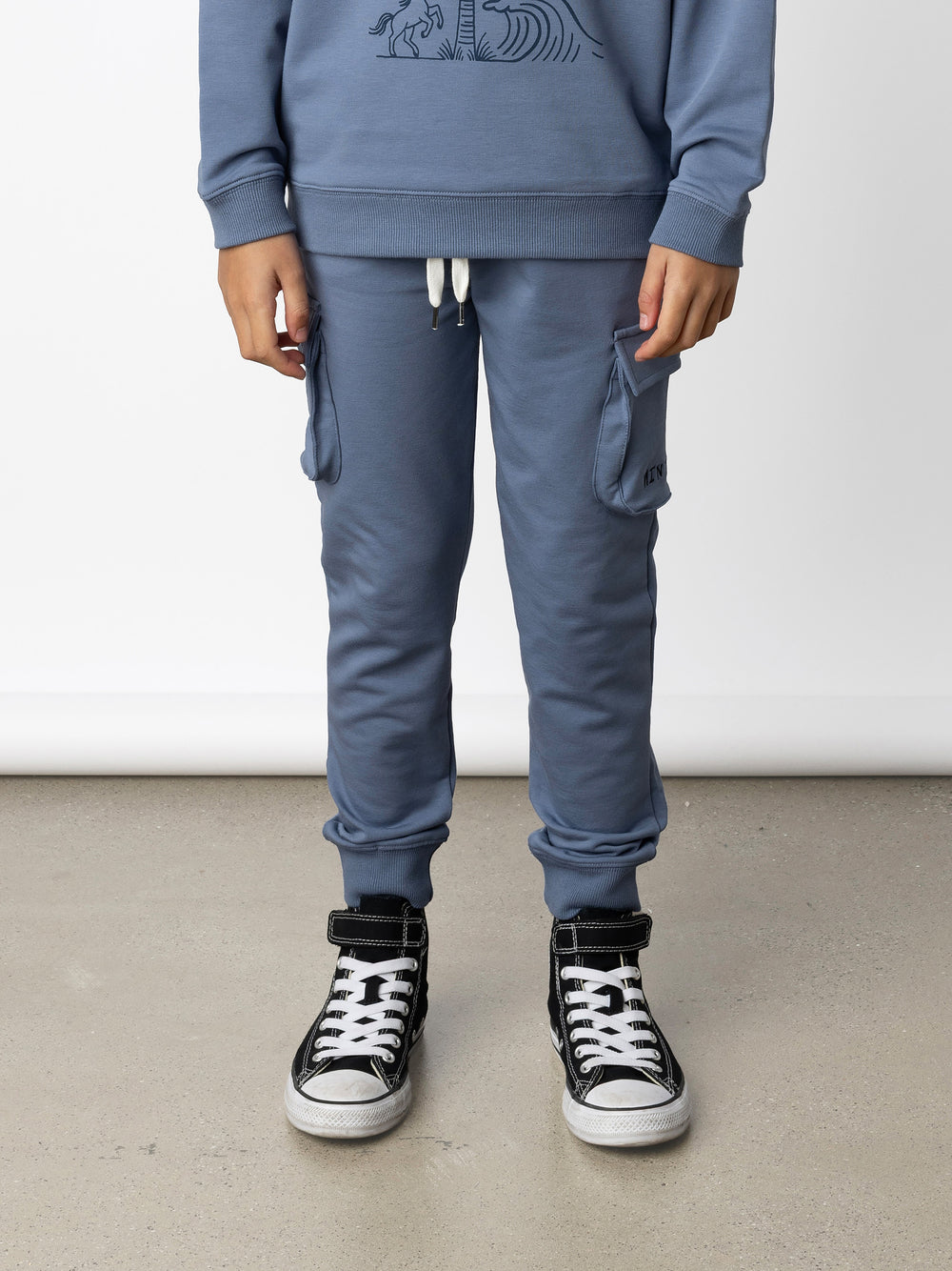 Minti kids clothing. Tapered leg trackies with awesome cargo style pockets, front pockets, shoelace cord and 2x2 rib waistband and cuffs. 320 Gram // 95% Cotton // 5% Elastane.