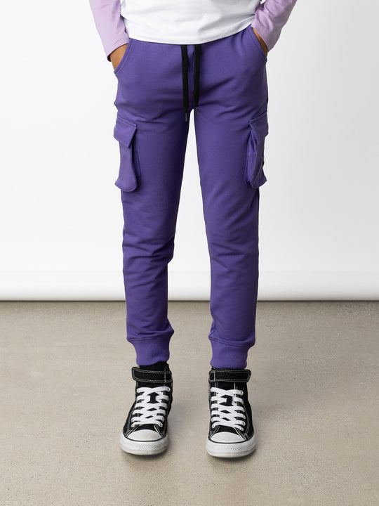 Minti kids clothing. Tapered leg trackies with awesome cargo style pockets, front pockets, shoelace cord and 2x2 rib waistband and cuffs. 320 Gram // 95% Cotton // 5% Elastane.