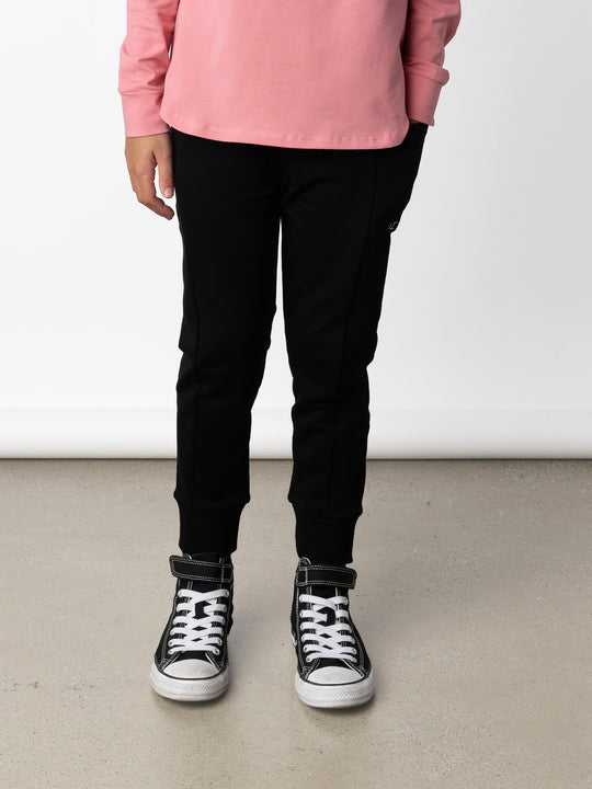 Minti kids clothing. Super cosy slip on trackies with elasticated waistband, drop crotch, super cool side pockets and 2x2 rib cuffs. 320 Gram // 95% Cotton // 5% Elastane.