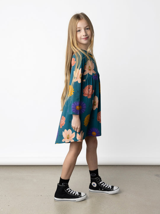 Minti kids clothing. Comfy tshirting weight dress with curved ruched front seam, hidden side pockets and scooped back hem. 190 Gram // 95% Cotton // 5% Elastane.