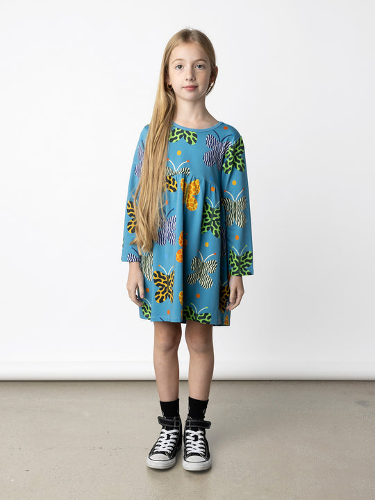 Minti kids clothing. Comfy tshirting weight dress with curved ruched front seam, hidden side pockets and scooped back hem. 190 Gram // 95% Cotton // 5% Elastane.