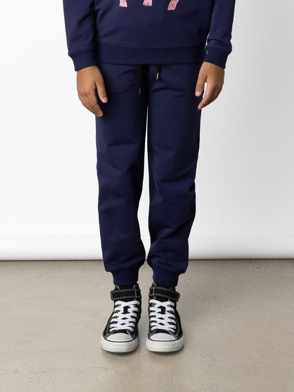 Minti kids clothing. Relaxed universal fit trackies with cosy side pockets, elasticated waistband, shoelace cord and 2x2 Rib cuffs. Small Minti embroidery on the back. 320 Gram // 95% Cotton // 5% Elastane.