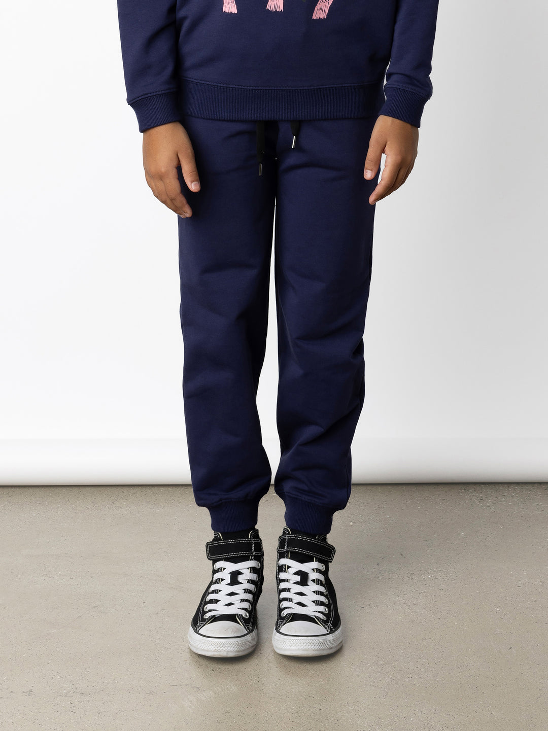 Minti kids clothing. Relaxed universal fit trackies with cosy side pockets, elasticated waistband, shoelace cord and 2x2 Rib cuffs. Small Minti embroidery on the back. 320 Gram // 95% Cotton // 5% Elastane.