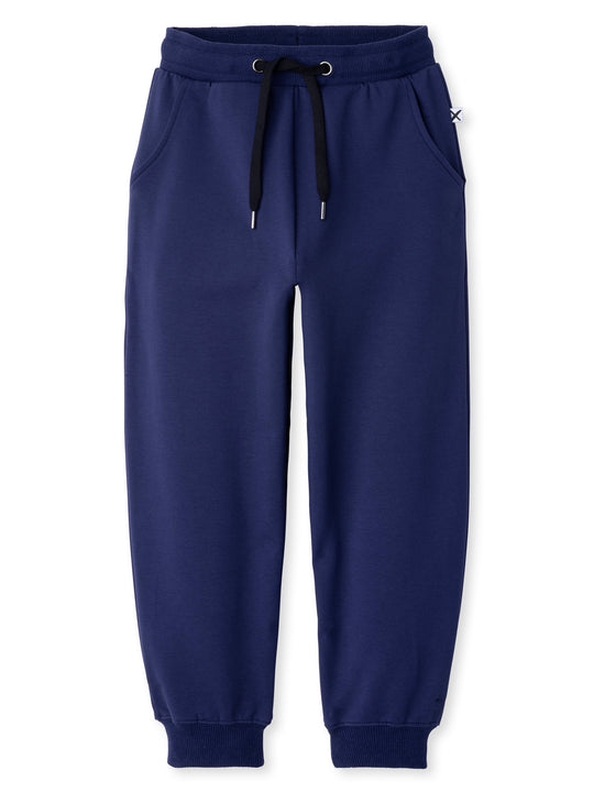 Minti kids clothing. Relaxed universal fit trackies with cosy side pockets, elasticated waistband, shoelace cord and 2x2 Rib cuffs. Small Minti embroidery on the back. 320 Gram // 95% Cotton // 5% Elastane.
