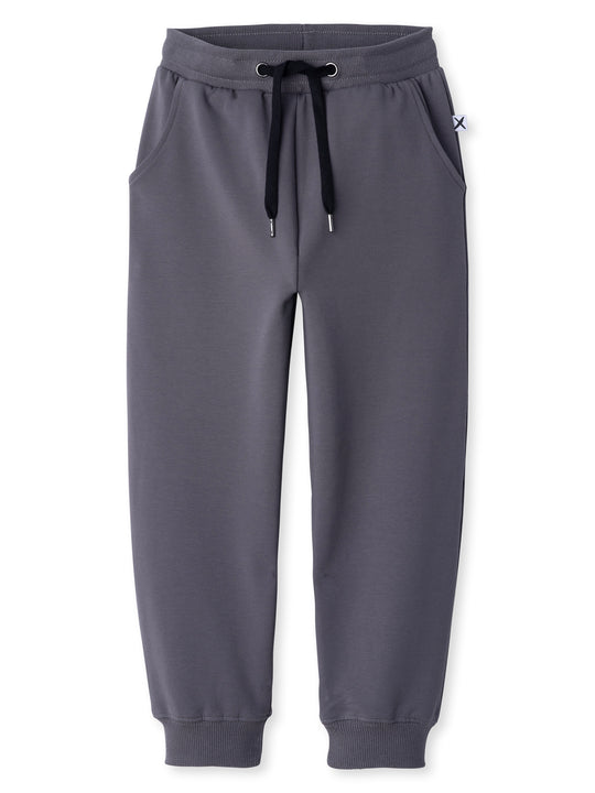 Minti kids clothing. Relaxed universal fit trackies with cosy side pockets, elasticated waistband, shoelace cord and 2x2 Rib cuffs. Small Minti embroidery on the back. 320 Gram // 95% Cotton // 5% Elastane.