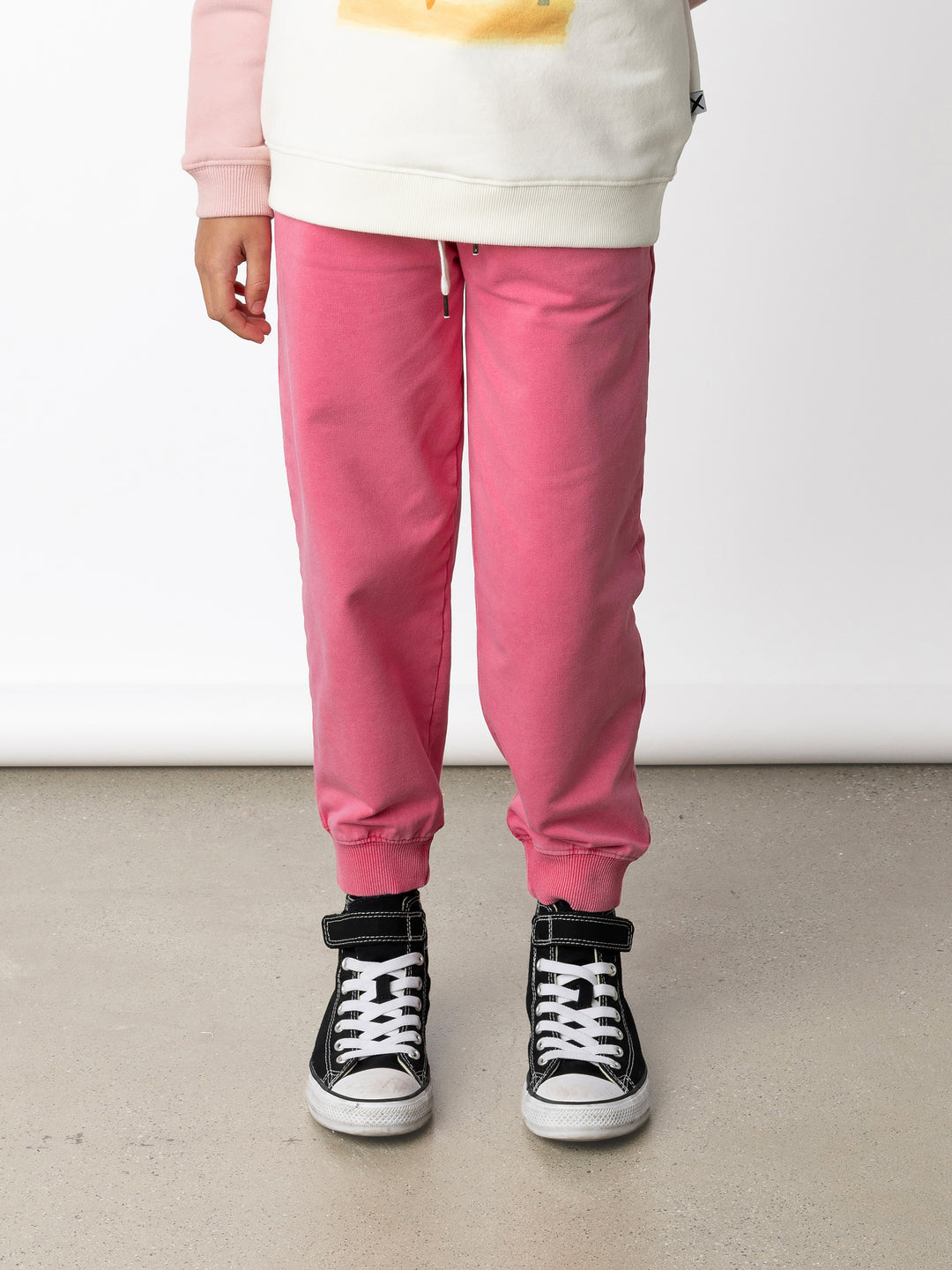 Minti kids clothing. Relaxed universal fit trackies with cosy side pockets, elasticated waistband, shoelace cord and 2x2 Rib cuffs. Small Minti embroidery on the back. 260 Gram // 95% Cotton // 5% Elastane.