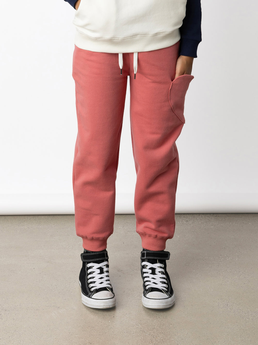 Minti kids clothing. Relaxed fit trackies with a super cool heart shaped side pocket. Front pockets, elasticated waistband, shoelace cord and 2x2 Rib cuffs. 330 Gram // Brushed Inside // 95% Cotton // 5% Elastane.