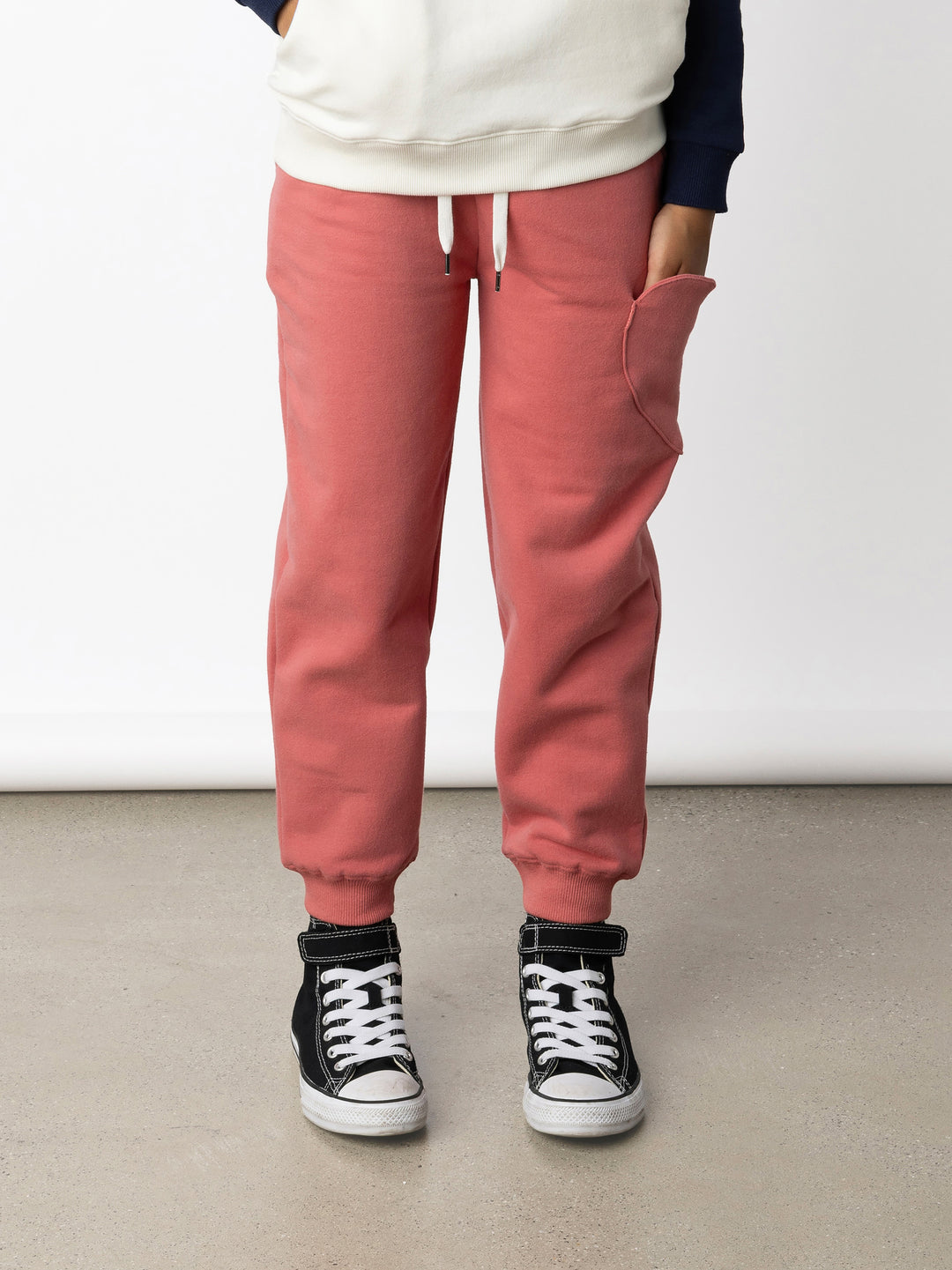 Minti kids clothing. Relaxed fit trackies with a super cool heart shaped side pocket. Front pockets, elasticated waistband, shoelace cord and 2x2 Rib cuffs. 330 Gram // Brushed Inside // 95% Cotton // 5% Elastane.