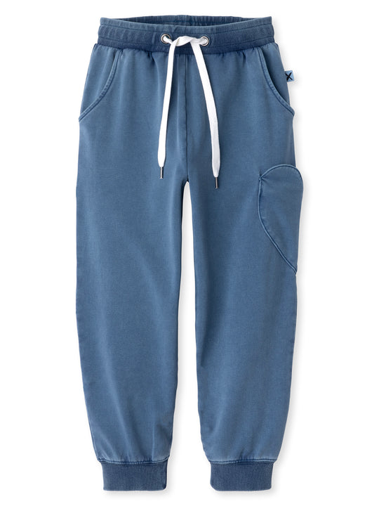 Minti kids clothing. Relaxed fit trackies with a super cool heart shaped side pocket. Front pockets, elasticated waistband, shoelace cord and 2x2 Rib cuffs. 260 Gram // 95% Cotton // 5% Elastane.