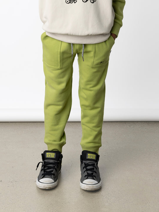 Minti kids clothing. Loose leg trackies with elasticated waistband, shoelace ties, 2x2 rib cuffs and super cool boxy pockets. 330 Gram // Brushed Inside // 95% Cotton // 5% Elastane.