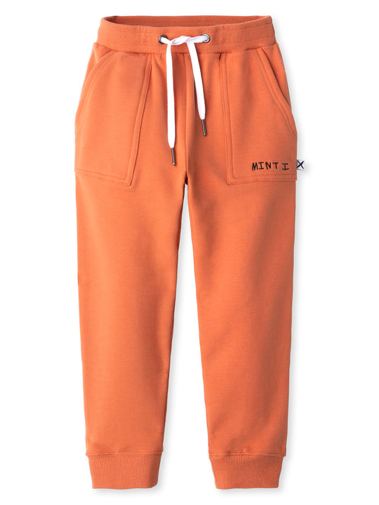 Minti kids clothing. Loose leg trackies with elasticated waistband, shoelace ties, 2x2 rib cuffs and super cool boxy pockets. 330 Gram // Brushed Inside // 95% Cotton // 5% Elastane.