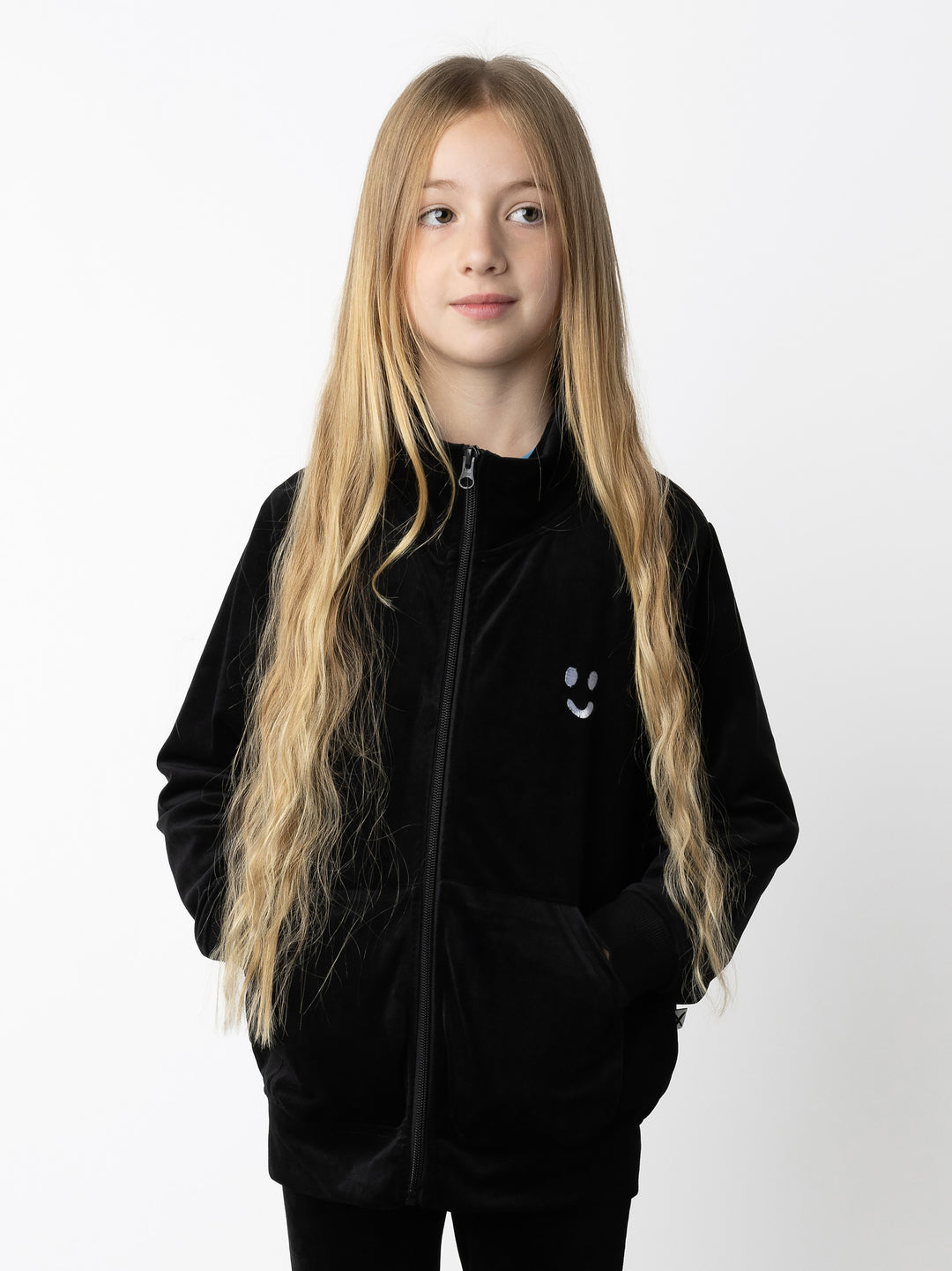 Minti kids clothing. Super cosy and soft zip up high neck crew, made in super soft velvet. Front kangaroo pocket to keep hands warm. Small Happy Face embroidery on the front. 92% Polyester // 8% Spandex.
