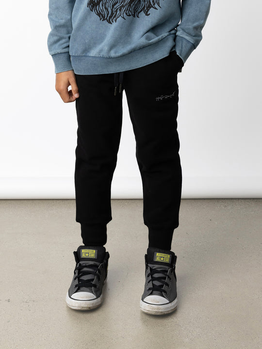 Minti kids clothing. Straight leg trackies with rounded front pockets, elastic waistband, shoelace ties, 2x2 rib cuffs and a small embroidery on the front. 330 Gram // Brushed Inside // 95% Cotton // 5% Elastane.