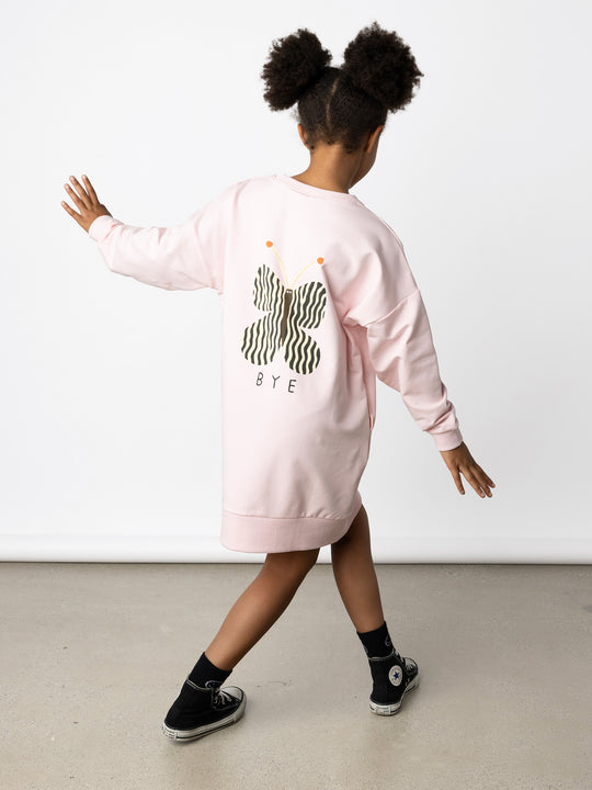 Minti kids clothing. Super cosy sweatshirting weight dress with drop shoulder detail. 2x2 Rib at the neck, hem and cuffs. Hidden side pockets. Print on the front and the back. 320 Gram // 95% Cotton // 5% Elastane.