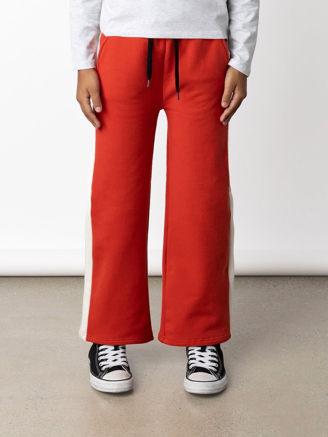 Minti kids clothing. Super relaxed fit wide leg trackies with cool contrast side panel. Elasticated waistband with shoelace cord, and front pockets to keep hands warm. Small Minti embroidery on the back. 330 Gram // Brushed Inside // 95% Cotton // 5% Elastane.