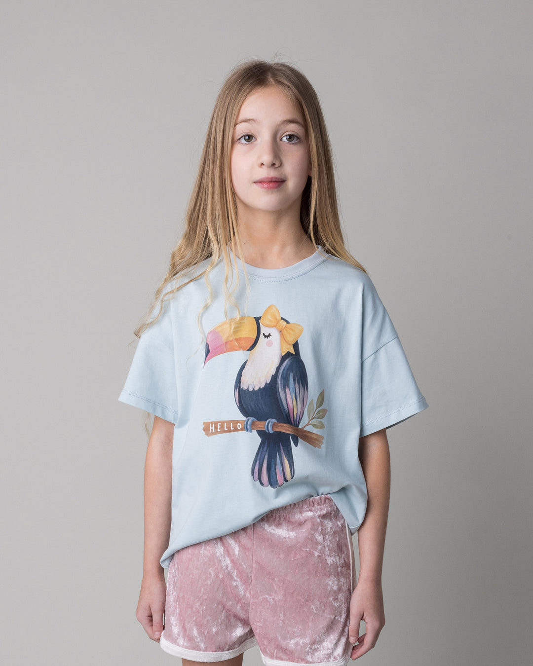 Close up of the Hello Toucan Tee in light blue on a kid, front view