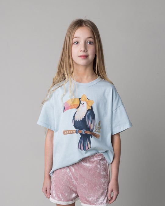 Close up of the Hello Toucan Tee in light blue on a kid, front view