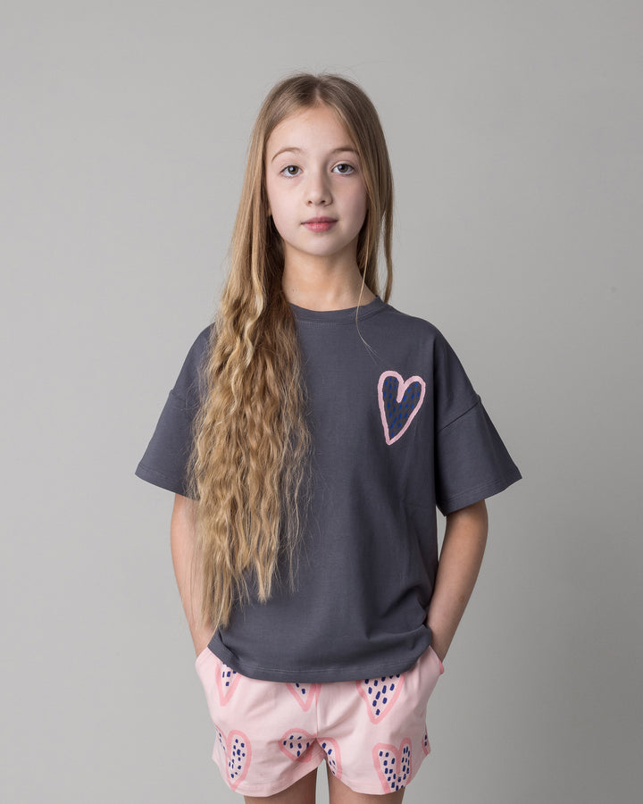 Close up of the Speckle Heart Tee in dark grey on a kid, front view
