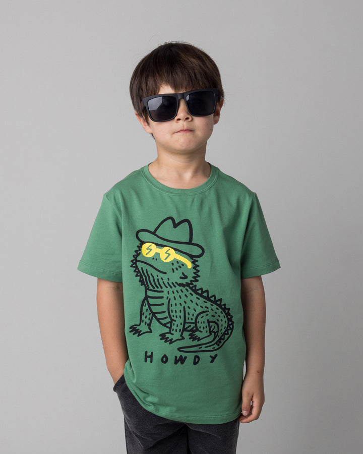 Close up of the Howdy Lizard Tee in turf on a kid, front view