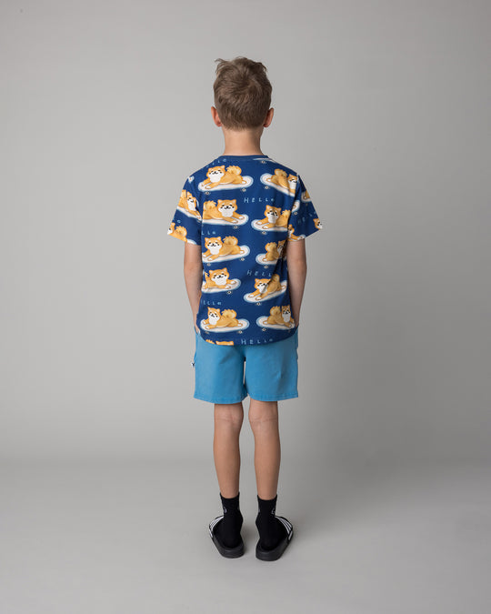Kid wearing the Skate Puppy Tee in midnight with the Blasted Track Short in sky wash, back view