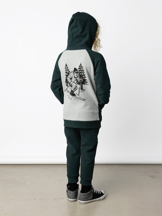 Minti kids clothing. Cosy zip through hoodie with kangaroo pockets for extra warmth! 2x2 rib trim on the hood, cuffs and hem. Small embroidery on the front and big print on the back. 330 Gram // Brushed Inside // 95% Cotton // 5% Elastane.