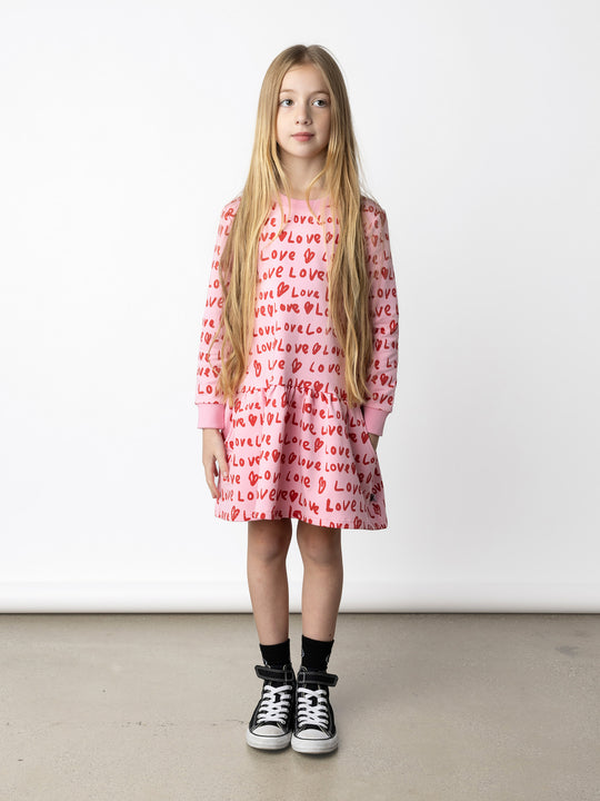 Minti kids clothing. Super cool sweatshirting weight dress with dropped skirt hem, pockets and ruching at the skirt seam. 320 Gram // 95% Cotton // 5% Elastane.