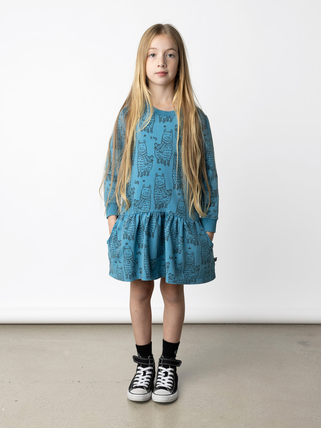 Minti kids clothing. Super cool sweatshirting weight dress with dropped skirt hem, pockets and ruching at the skirt seam. 260 Gram // 95% Cotton // 5% Elastane.