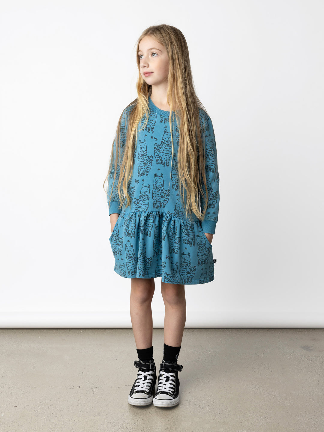 Minti kids clothing. Super cool sweatshirting weight dress with dropped skirt hem, pockets and ruching at the skirt seam. 260 Gram // 95% Cotton // 5% Elastane.