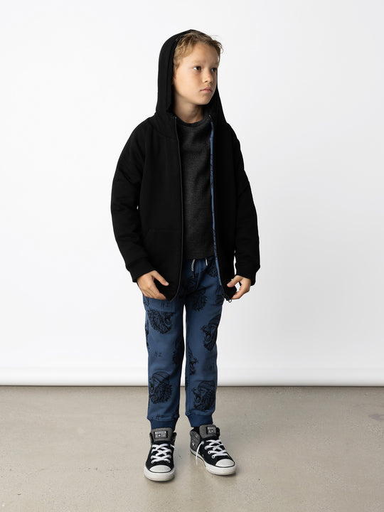 Minti kids clothing. Super cosy two-in-one Zip Up! One side is plain black with a kangaroo front pocket, the other side has our awesome Roar yardage and a contrast HI embroidery! Perfect for all occasions and super warm! 330 Gram // Brushed Inside // 95% Cotton // 5% Elastane.