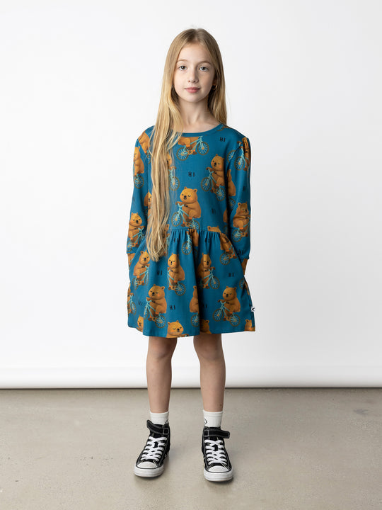 Minti kids clothing. Tshirting weight dress with self cuffs, hidden side pockets and waist seam with ruching detail. 190 Gram // 95% Cotton // 5% Elastane.