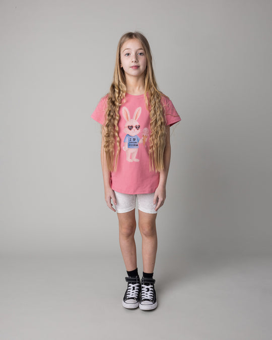 Kid wearing the Icecream Bunny Tee in candy with the Velvet Bike Pant in cream, front view
