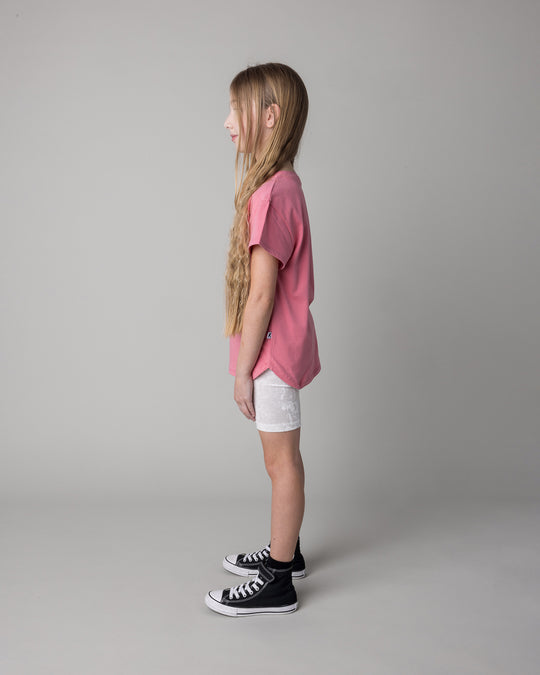 Kid wearing the Icecream Bunny Tee in candy with the Velvet Bike Pant in cream, side view