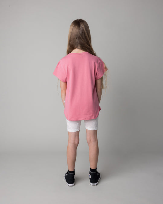 Kid wearing the Icecream Bunny Tee in candy with the Velvet Bike Pant in cream, back view