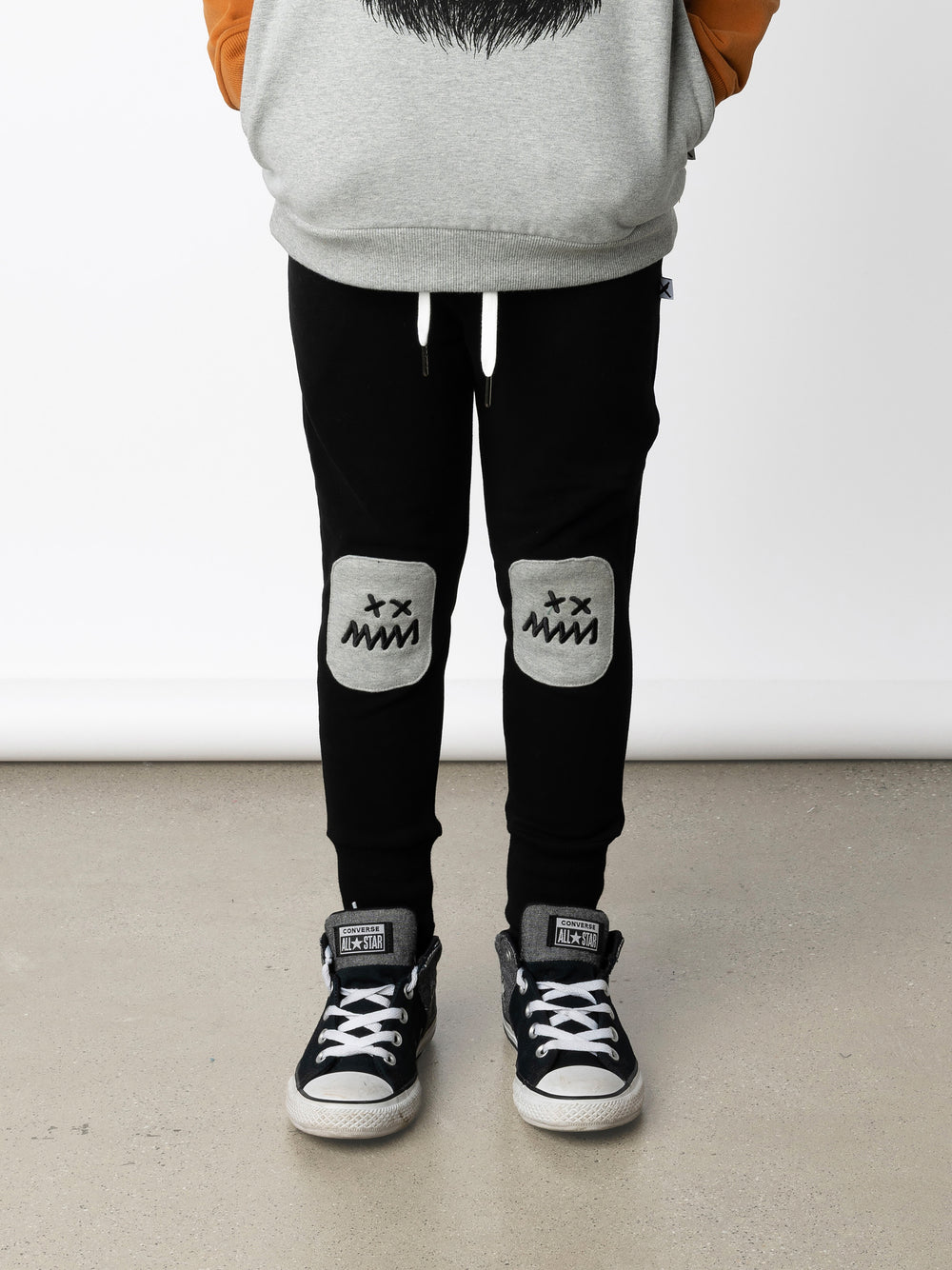 Minti kids clothing. Luxe trackies with sewn on patch knees, front pockets and shoelace ties. Super cool embroideries on the knee patches. 330 Gram // Brushed Inside // 95% Cotton // 5% Elastane.