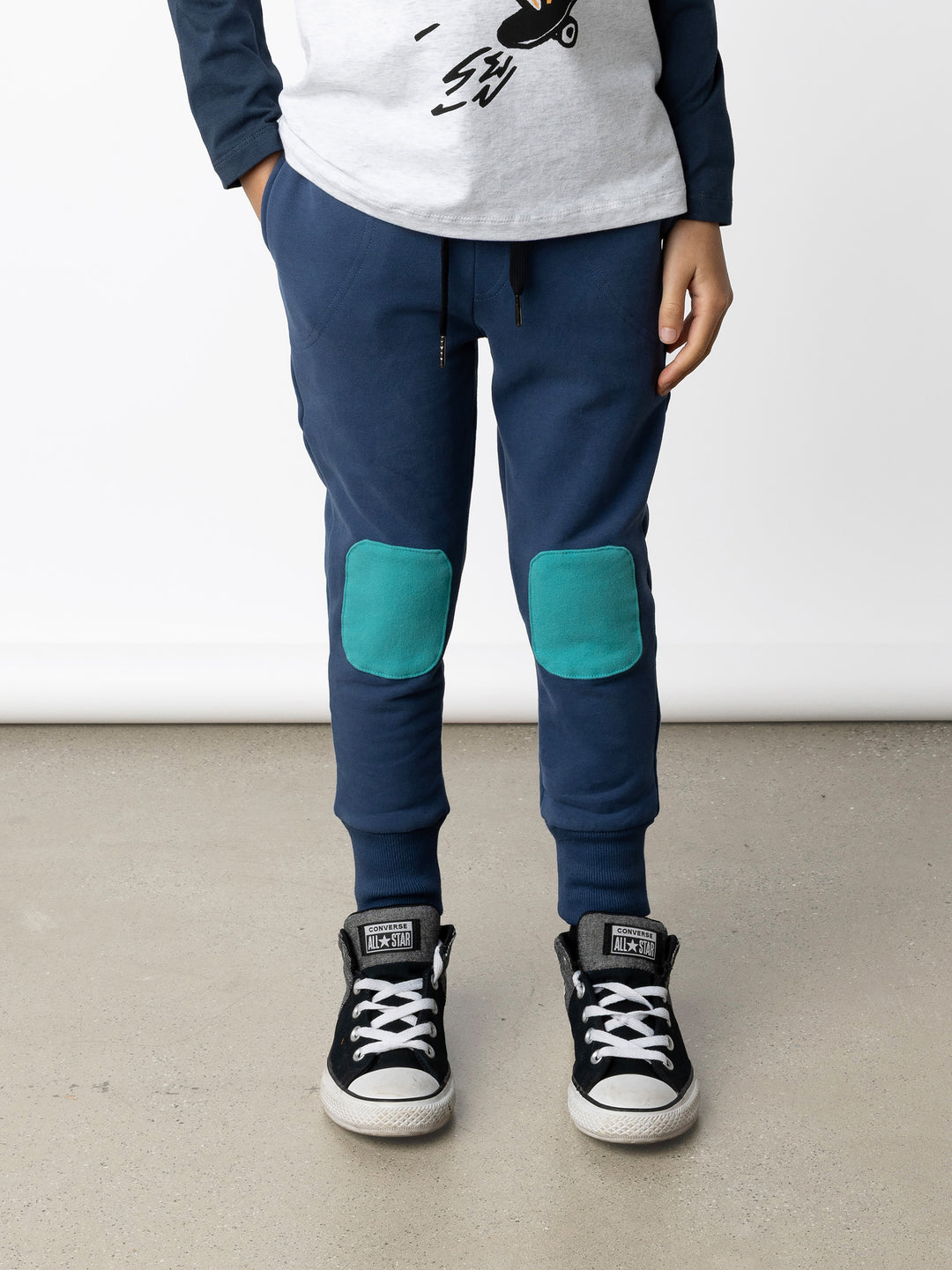 Minti kids clothing. Luxe trackies with sewn on patch knees, front pockets and shoelace ties. Small Minti embroidery on the back. 330 Gram // Brushed Inside // 95% Cotton // 5% Elastane.