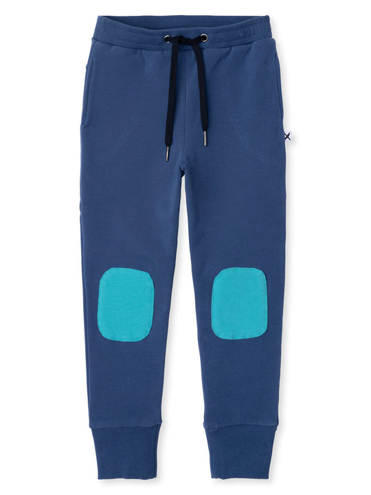 Minti kids clothing. Luxe trackies with sewn on patch knees, front pockets and shoelace ties. Small Minti embroidery on the back. 330 Gram // Brushed Inside // 95% Cotton // 5% Elastane.