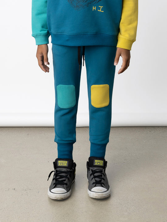 Minti kids clothing. Super luxe trackies with sewn on patch knees, front pockets and shoelace ties. Small Minti embroidery on the back. 260 Gram // 95% Cotton // 5% Elastane.