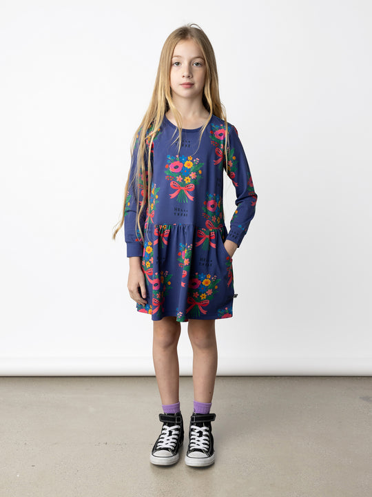 Minti kids clothing. Comfy tshirting weight dress with ruched skirt seam, front pockets and scooped back hem. 190 Gram // 95% Cotton // 5% Elastane.