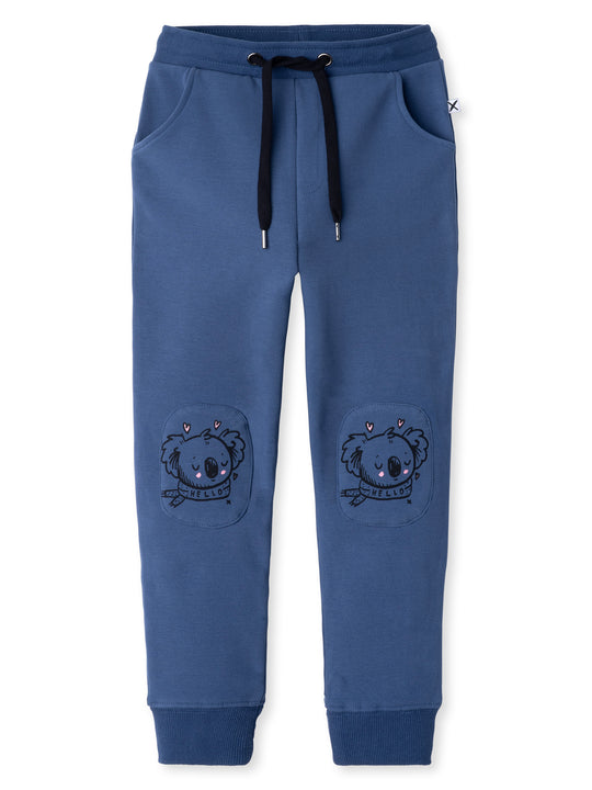 Minti kids clothing. Slim leg trackies with front pockets, shoelace cord and 2x2 rib waistband and cuffs. We recommend to go up a size for this style. 330 Gram // Brushed Inside // 95% Cotton // 5% Elastane.