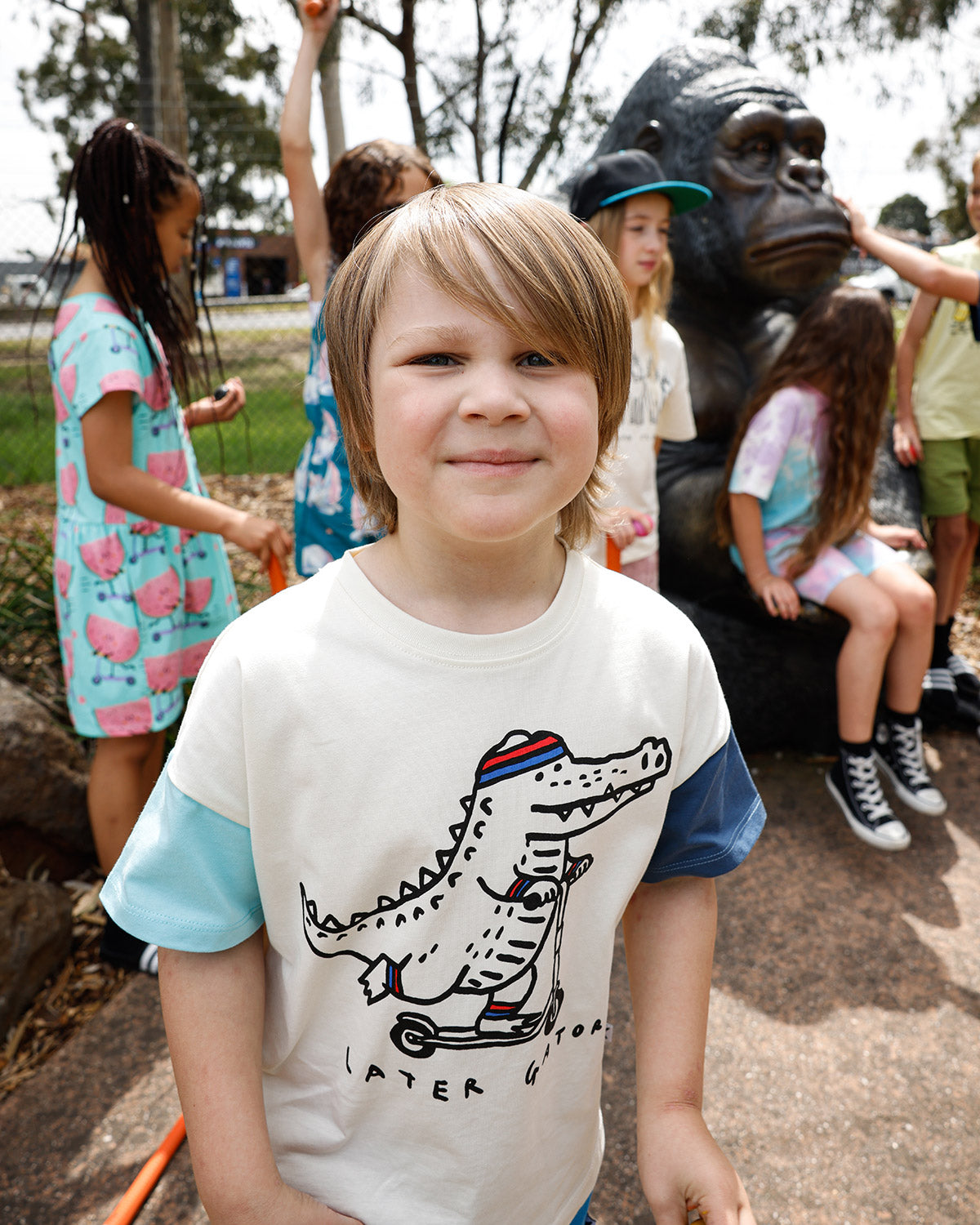 Kid in the Minti Later Gator tee at mini golf