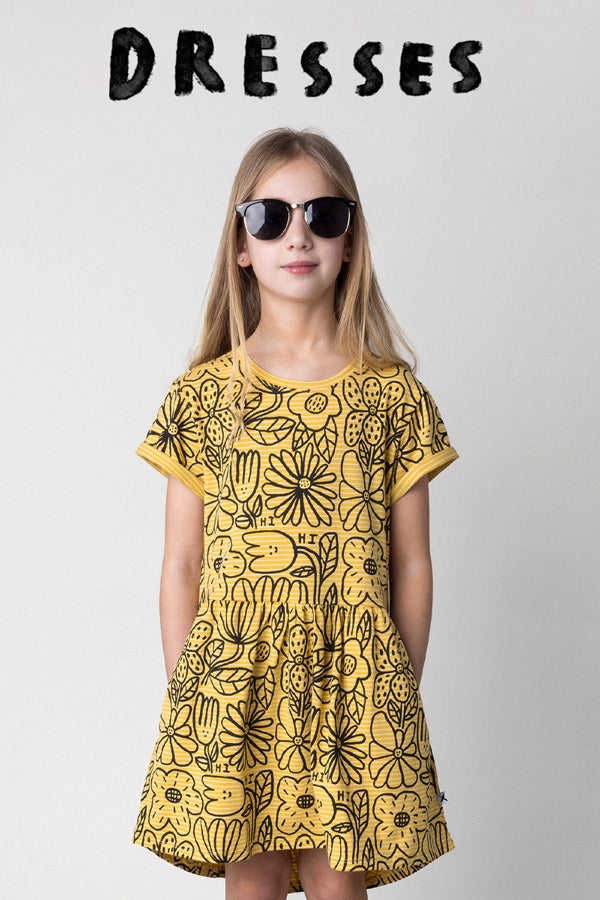 Shop dresses at Minti, kid wearing the Big Flowers Dress in mustard
