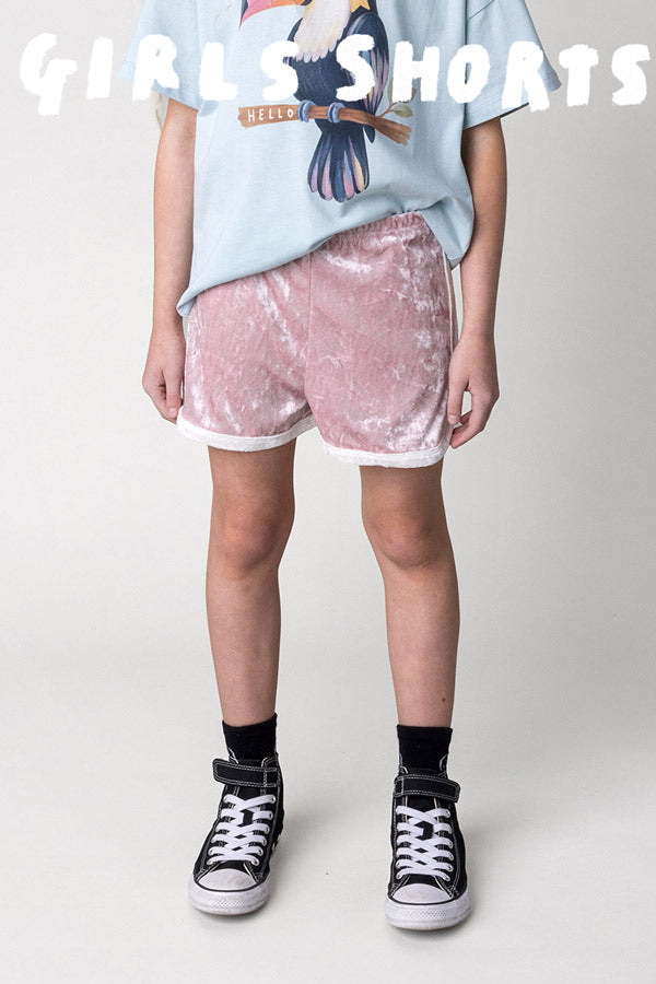Shop girls shorts at Minti, kid wearing the Velvet Runner Short in blush and cream